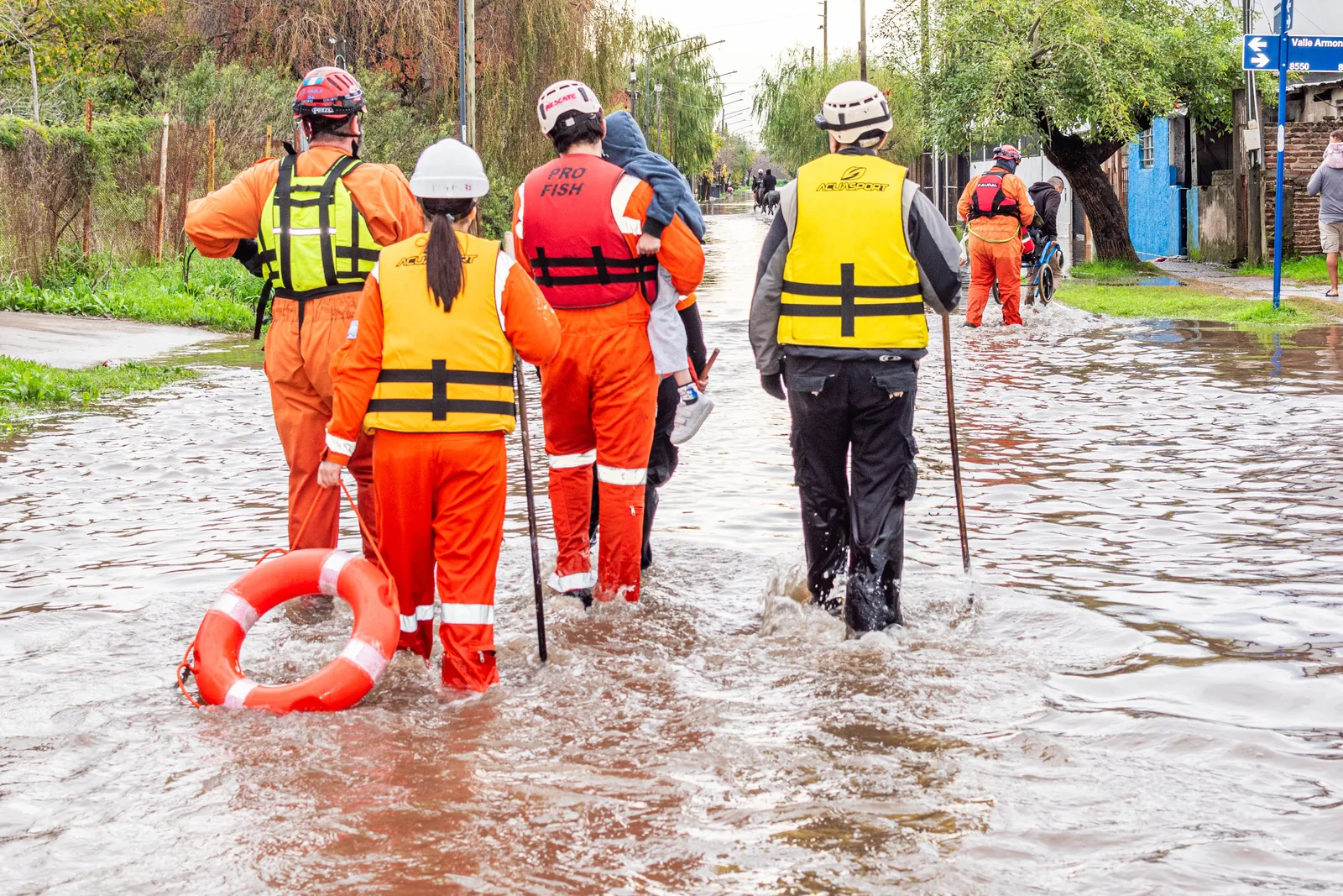 Rescue team wading through a flooded street